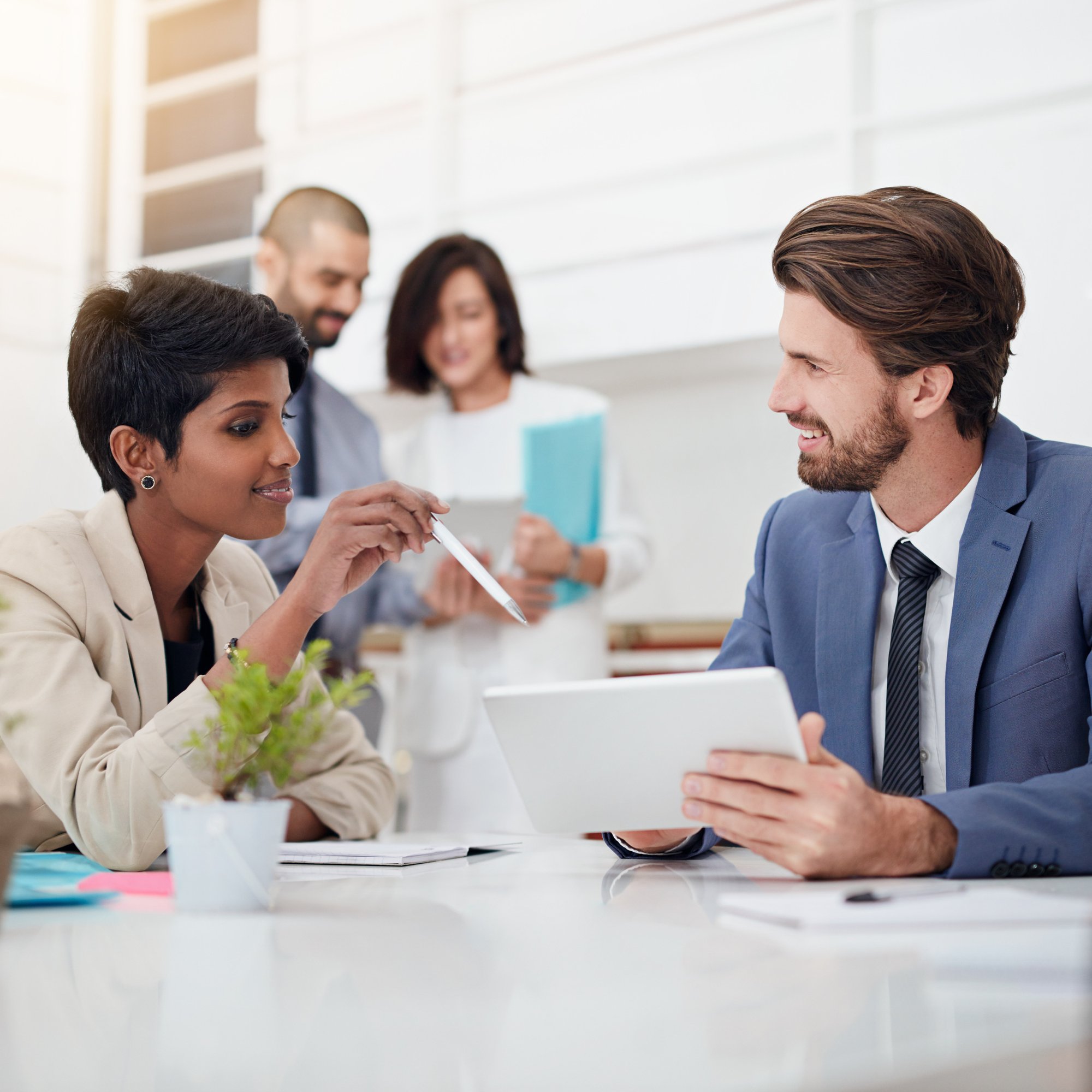 corporate-smile-pointing-tablet-people-conversation-financial-report-confident-discussion-teamwork-paperwork-meeting-talking-project-actuary-boardroom