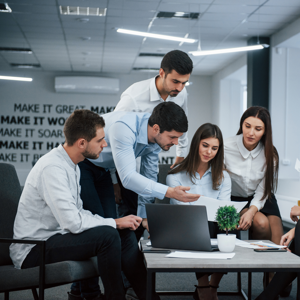 guy-shows-document-girl-group-young-freelancers-office-have-conversation-working